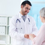 Confident doctor looking at his senior patient while speaking to her